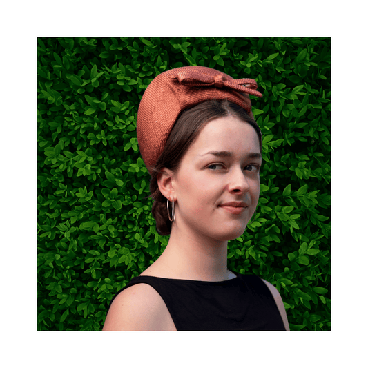 Model wearing a bronze turban by Jo Ramsay Millinery