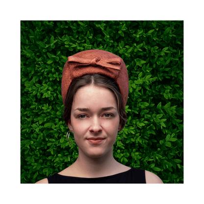 Model wearing a bronze turban by Jo Ramsay Millinery